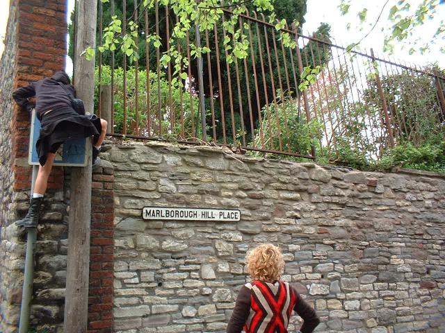 road sign embrace on to stone wall
