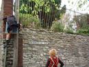 road sign embrace on to stone wall